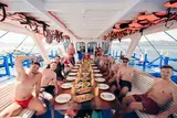 Travelers enjoying a multi-course grilled seafood buffet lunch on deck aboard the Seatours 3D2N expedition boat on a private 3D2N Palawan charter