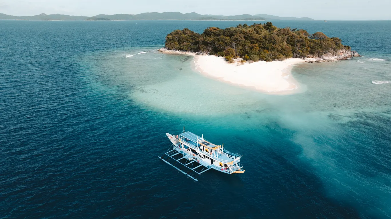 Speedboat crossing the karst-studded waters from El Nido to Coron, Palawan, Philippines