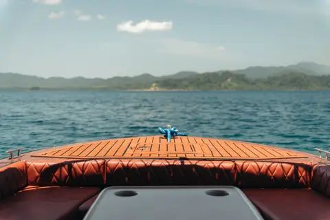 Premium speedboat bow deck with diamond-stitched seating and teak deck — Seatours semi-private El Nido tour