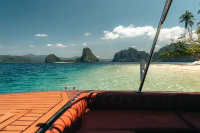 View from the Seatours speedboat bow toward limestone islands and turquoise Bacuit Bay — semi-private El Nido day tour